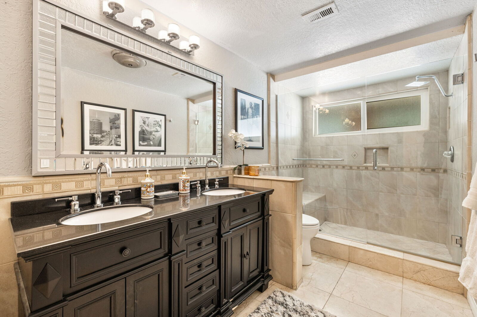 Second full bathroom with double vanity and a walk-in shower