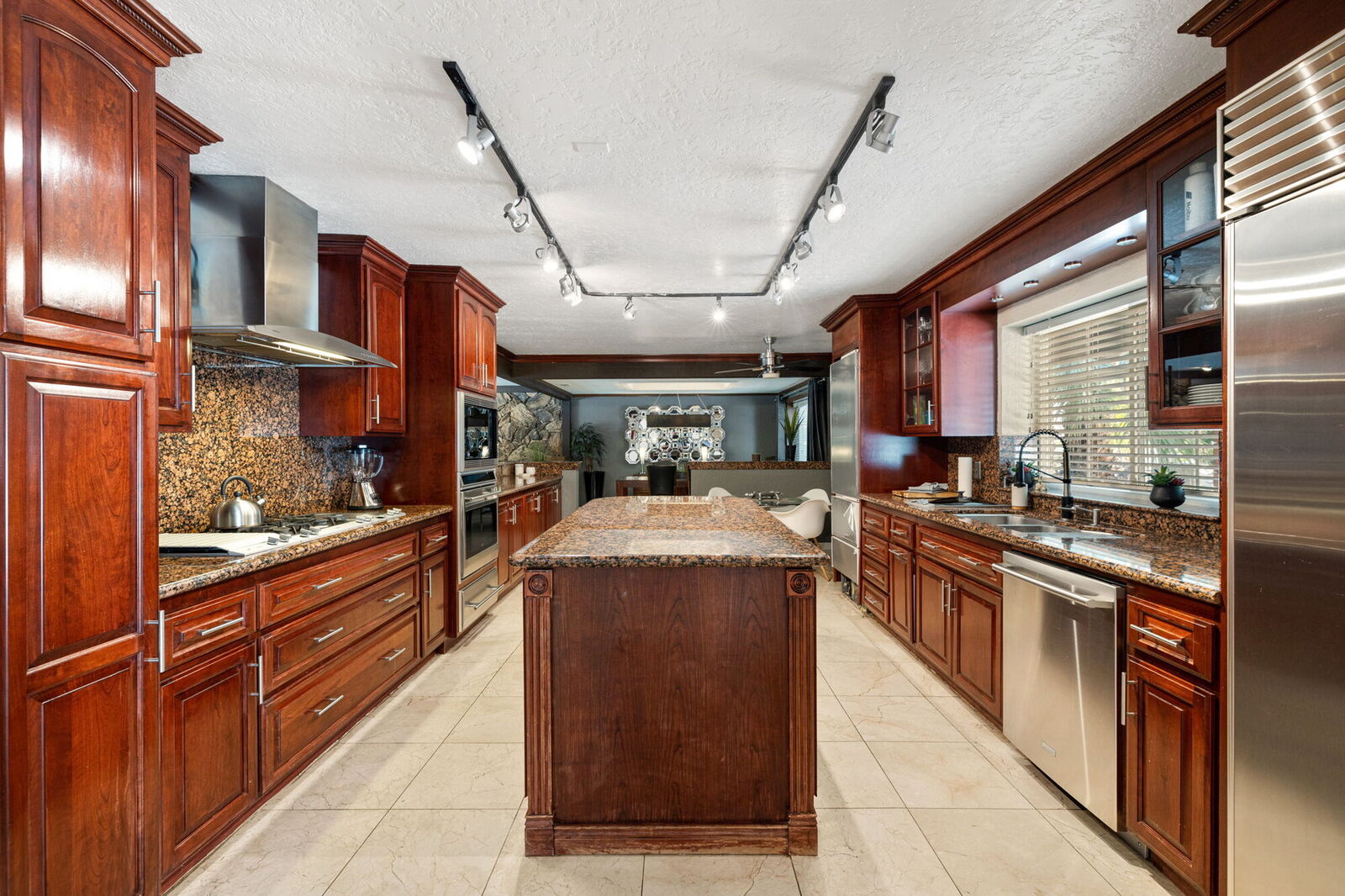 Chef's kitchen with cherry cabinetry, granite counters, and a center island